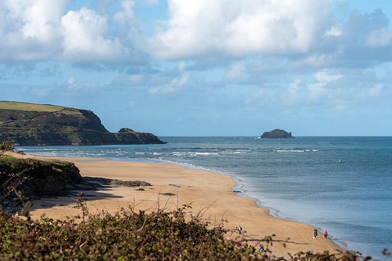 Walkers on a coastal footpath along the cliffs near Padstow, Cornwall
