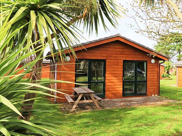 Sun cabin chalet exterior with decking at Atlantic Bays Holiday Park