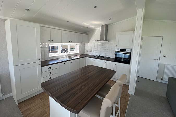 Lodge dining table and seating inside a luxury lodge at Atlantic Bays, St Merryn