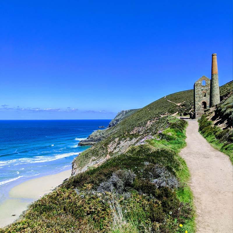 Walker on the coast path along the North Cornwall coastline